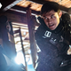 Henry Golding as Snake Eyes in Snake Eyes: G.I. Joe Origins leans down while wielding his sword and wearing all black.